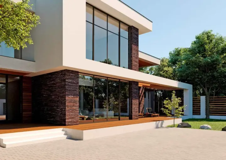 Fachadas de casas modernas con grandes ventanales y detalles en piedra. Una terraza de madera invita a disfrutar del exterior.
